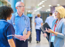 integration doctors talking in hospital corridor